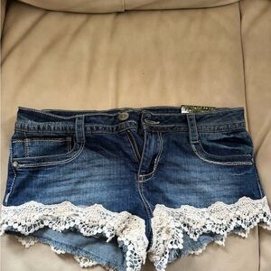 New with tags. Almost Famous Blue Jean Shorts with White Lace Trim Size 5